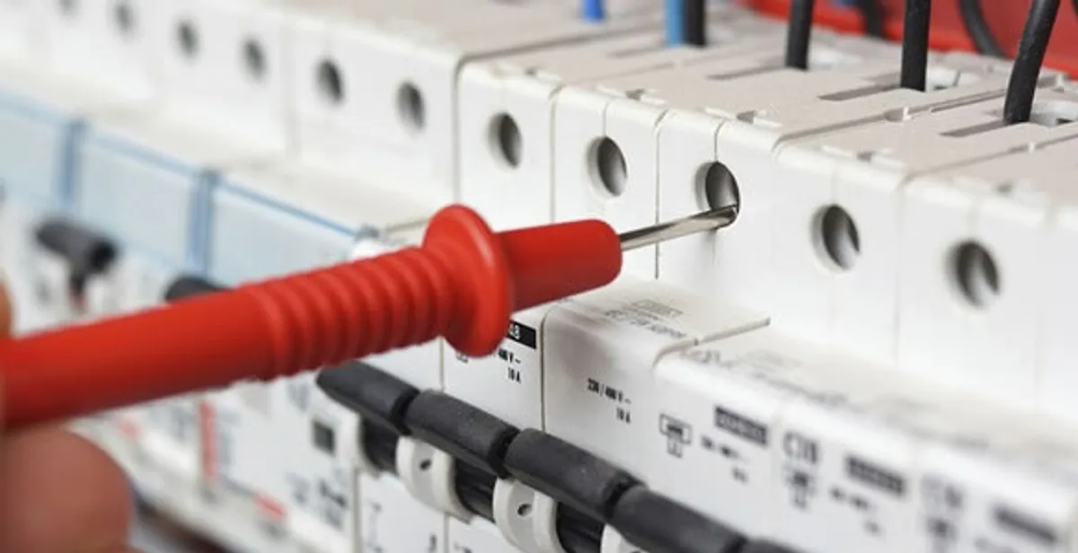 Electrical contractor testing circuit breakers during electrical repair in Oak Park, MI