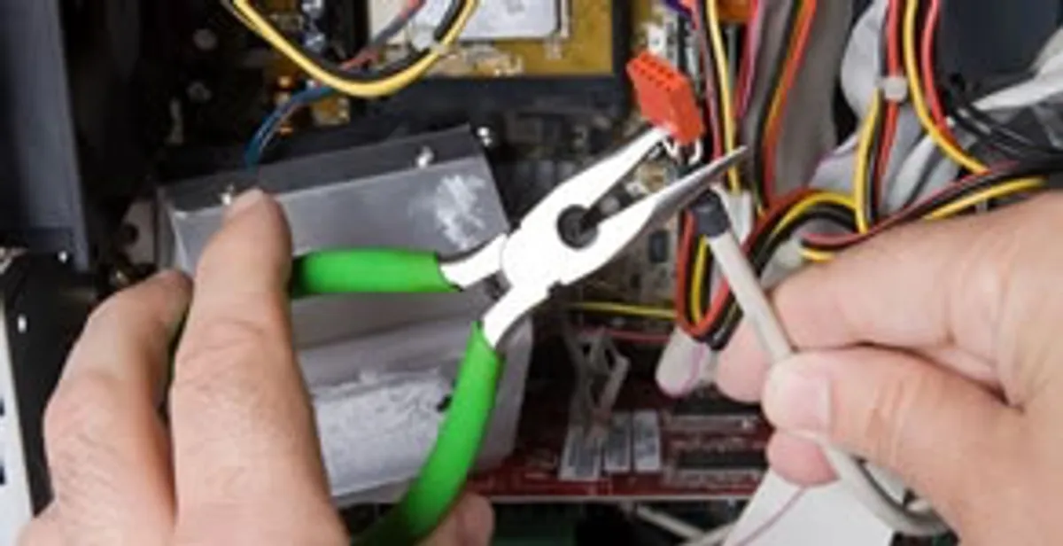 Licensed electrical contractor performing electrical repair with tools in Hazel Park, MI