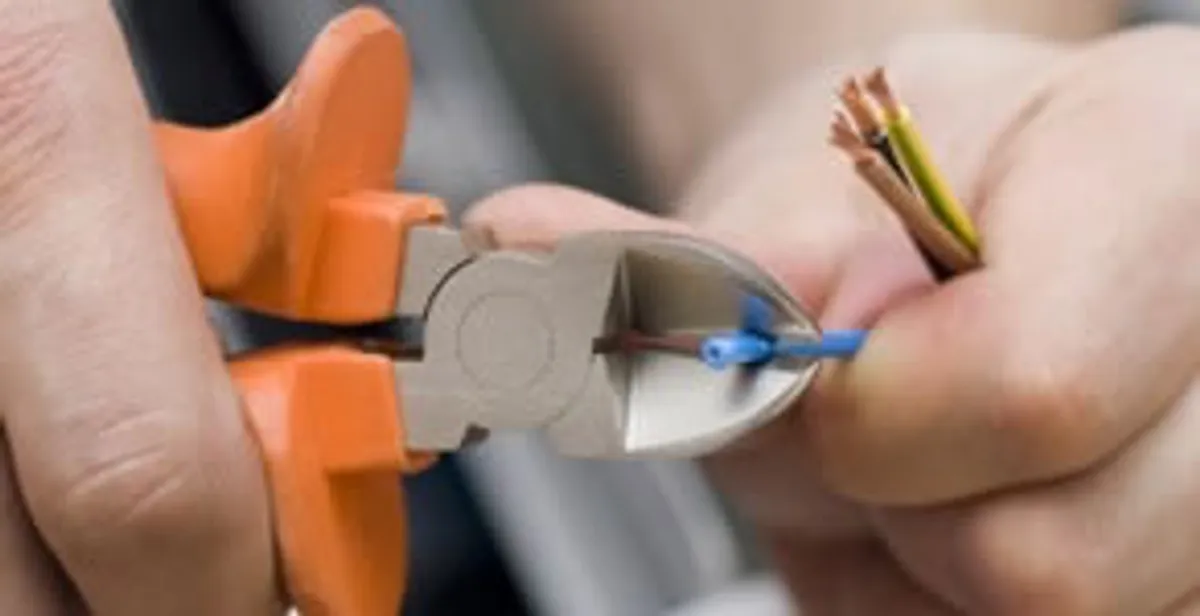 professional electrical services showing precise wire cutting by licensed electricians in Detroit, MI