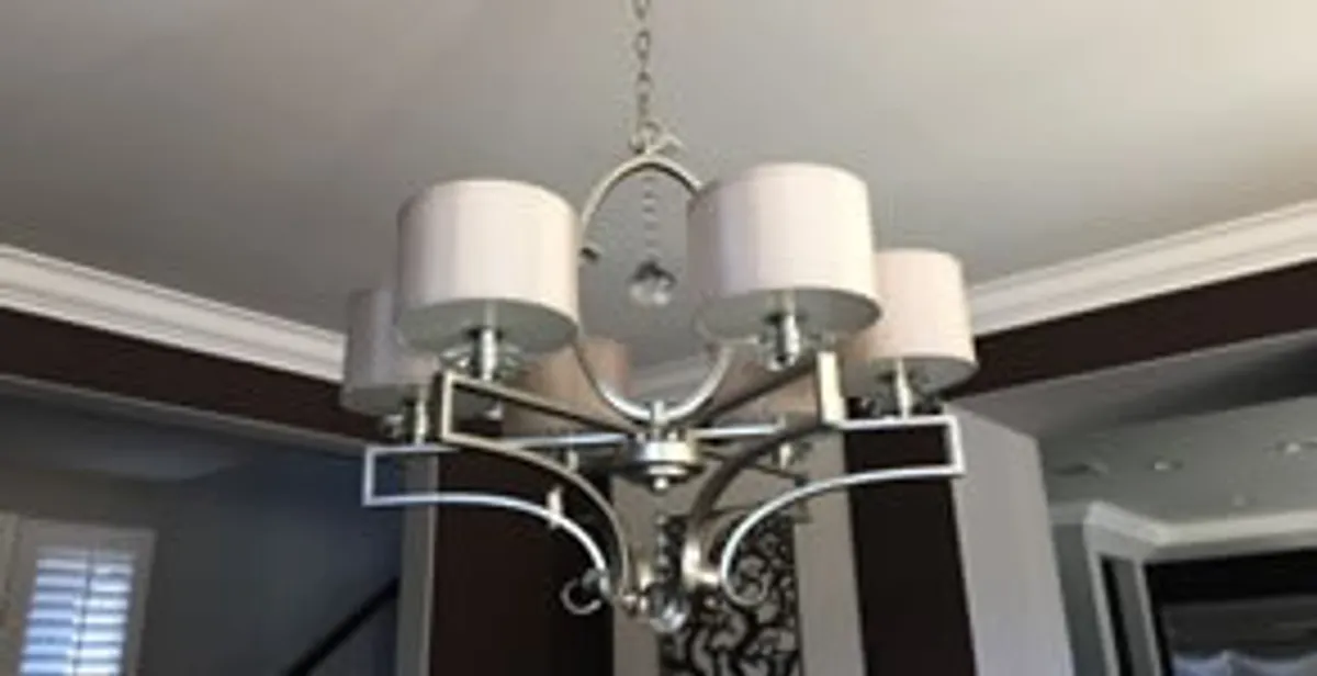 Modern chandelier installation with multiple light fixtures in Detroit, MI